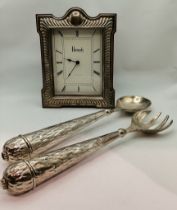 A Harrods silver-mounted mantel clock, and a pair of white metal salad servers