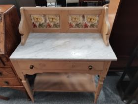 A pine washstand with tiled back