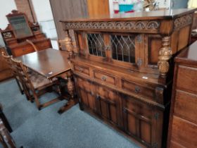 A 20th century oak court cupboard, dining table and 4 chairs