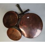 A graduated set of three copper skillets, early 20th Century