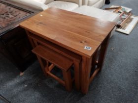 A nest of 3 modern oak tables