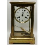 A brass-cased four glass crystal regulator mantel clock