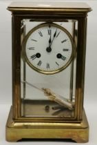 A brass-cased four glass crystal regulator mantel clock