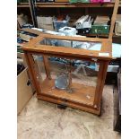 Laboratory chemical balance in glass display case