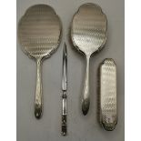 An Elizabeth II silver dressing table brush and mirror set, and a letter opener