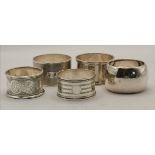 A harlequin group of five silver napkin rings