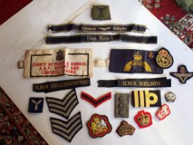 A collection of military badges and cloth insignia