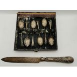 A Victorian silver cake knife and a cased set of six late Victorian gilded teaspoons