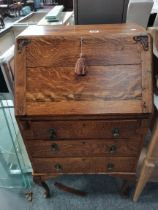 A 20th century oak bureau with carved fruit decoration, 1930's