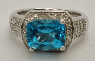 An 18 carat white gold topaz and diamond ring