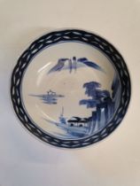 An early Chinese blue and white bowl with village scene and floral decoration
