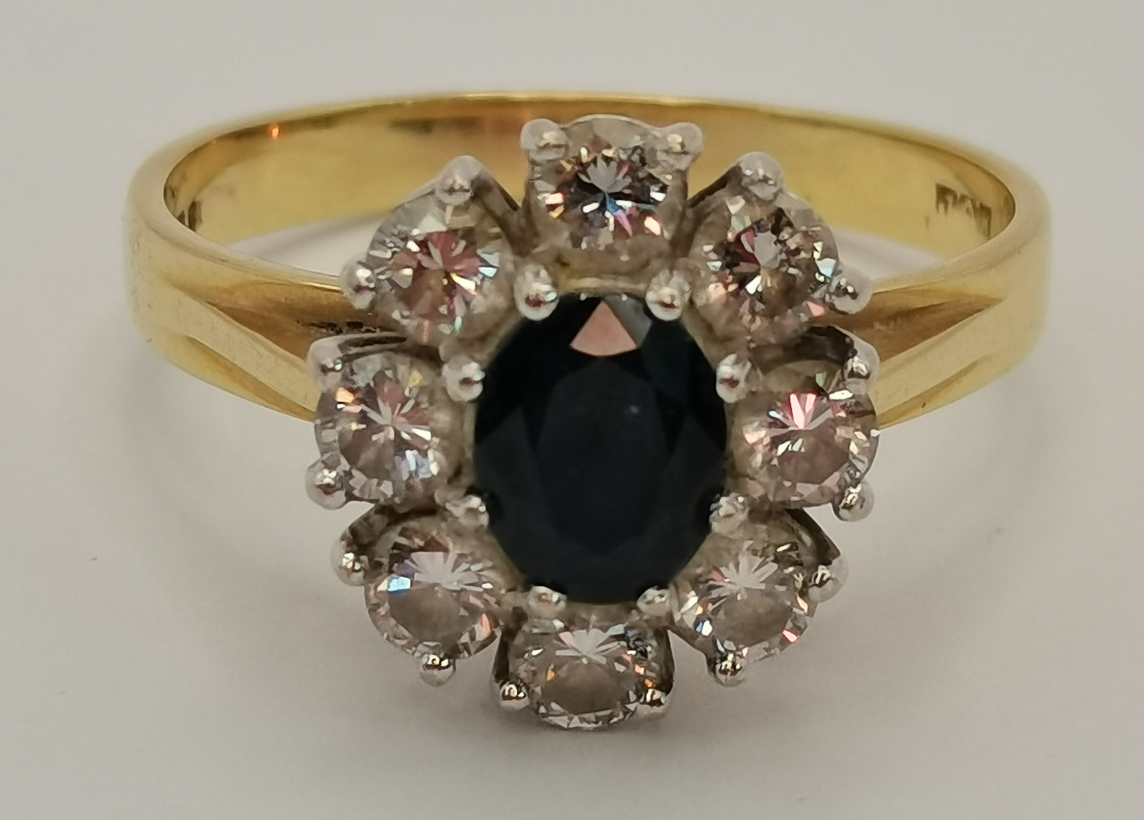 An 18 carat gold diamond and sapphire cluster ring