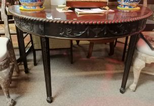 An Antique mahogany half moon table in the Chippen