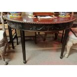 An Antique mahogany half moon table in the Chippen