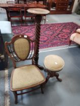 A Victorian nursing chair, a Victorian carved plant stand and a Victorian revolving piano
