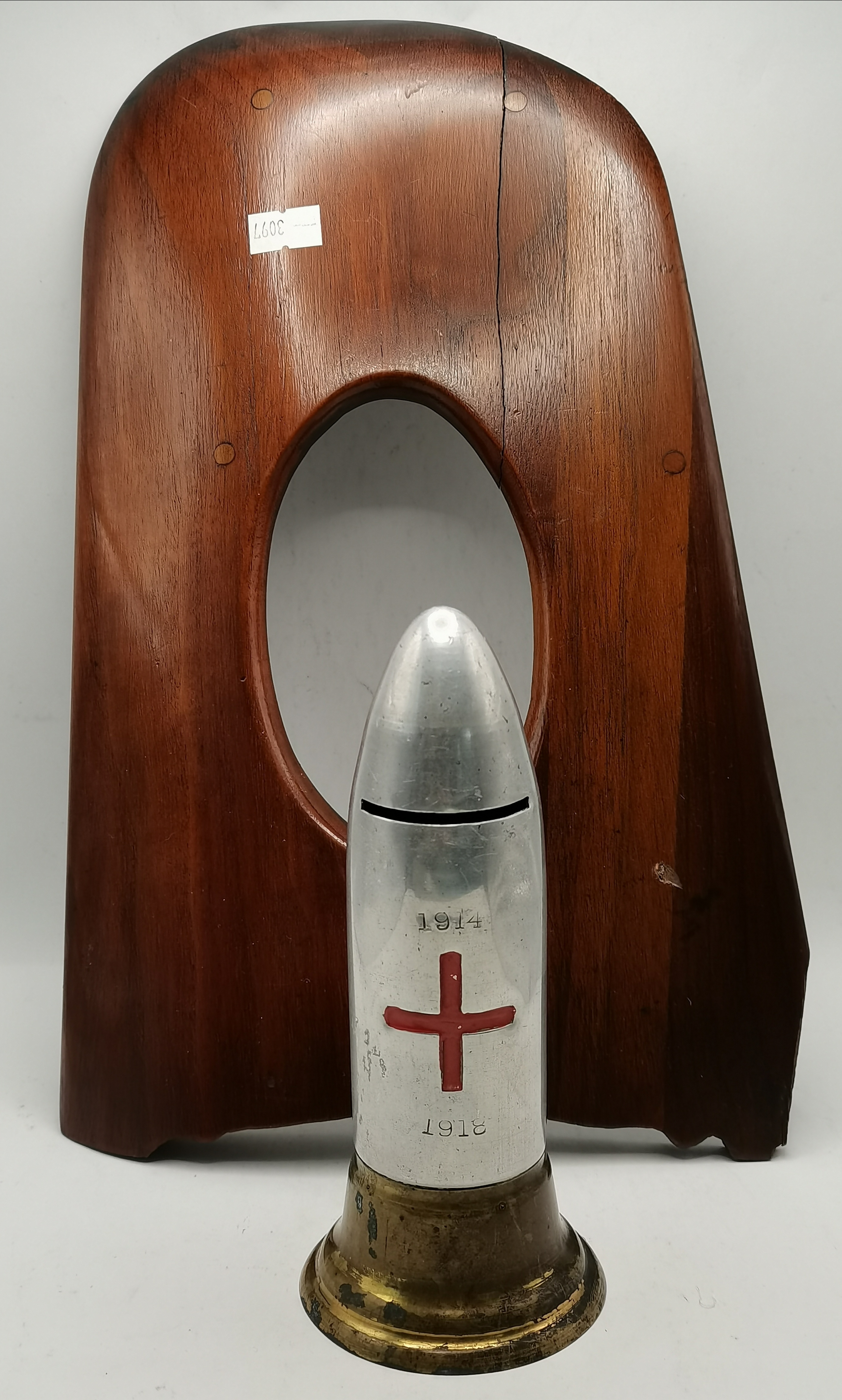 A WWI commemorative shell money box, and a wooden photograph frame