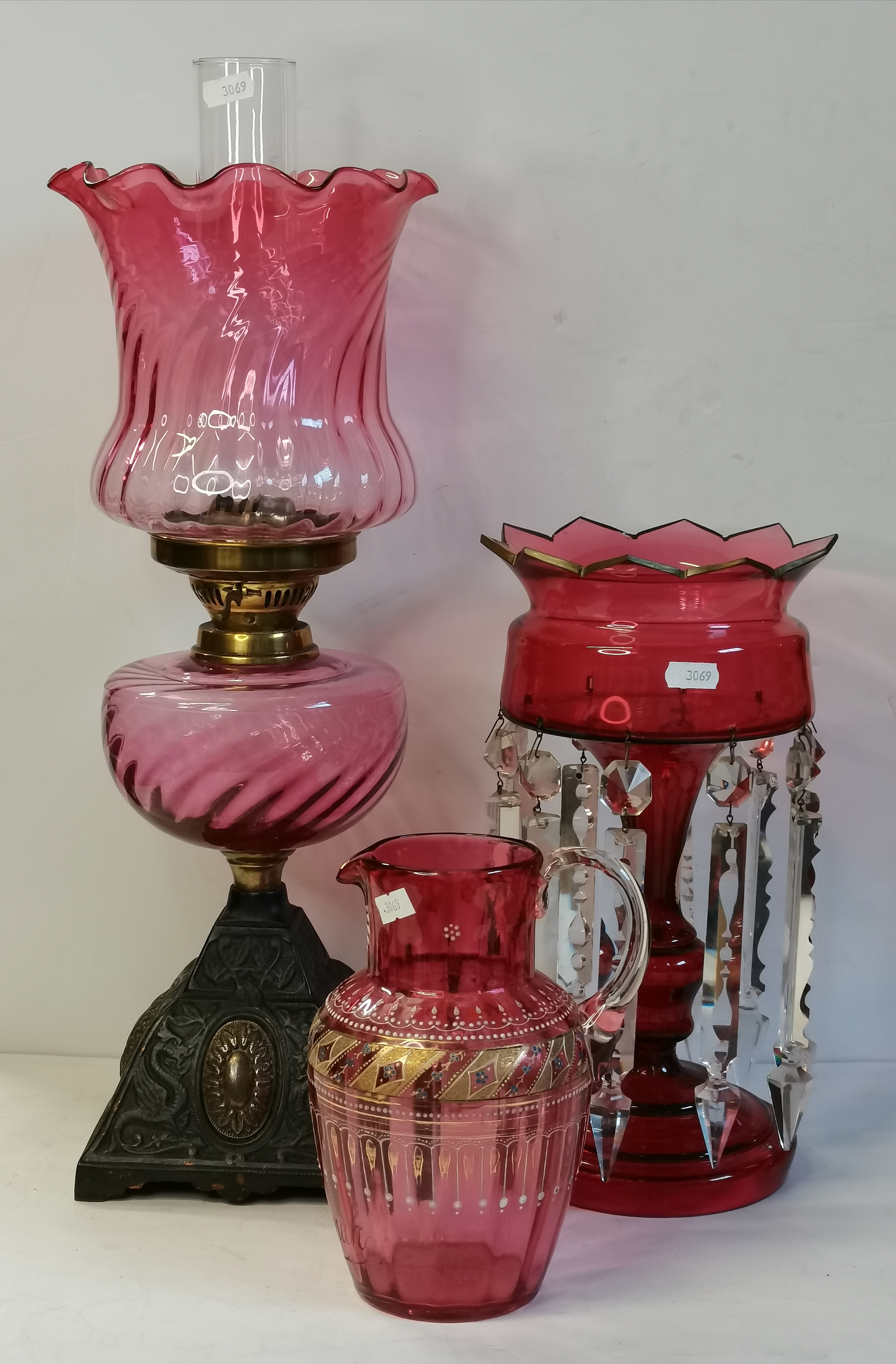 A group of cranberry glassware