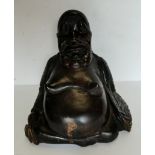 Antique carved hardwood figure of a seated buddha. 20.5cm high