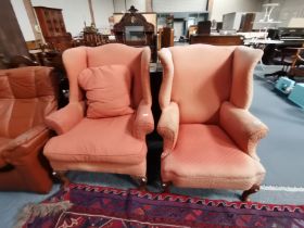 A near pair of Queen Anne style winged armchairs