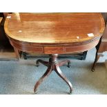 A Georgian mahogany tea table on a turned central