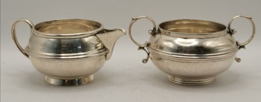 A 20th Century silver cream jug and twin-handled sugar bowl