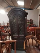 An early oak standing corner cupboard with decorat