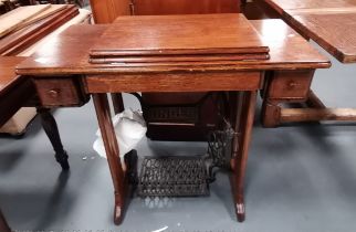A SINGER treadle sewing machine in oak case