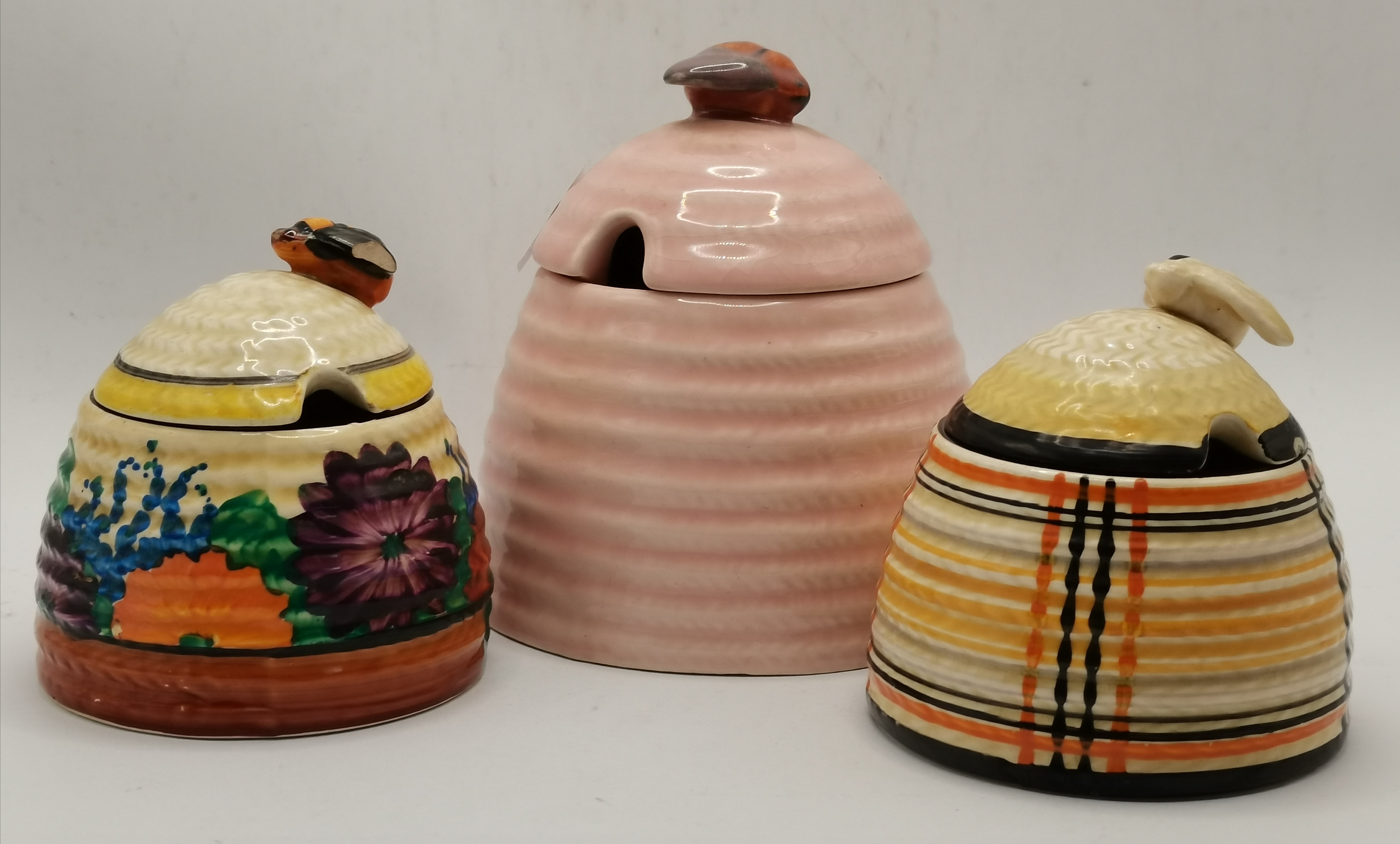 Clarice Cliff: Two Bizarre beehive honey pots, and another