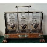 A large walnut tantalus with three square decanters