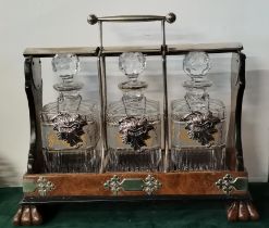 A large walnut tantalus with three square decanters