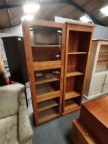A wooden bookcase and a triple-door tall cabinet