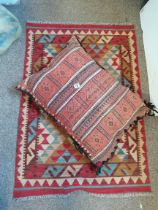 Red and cream patterned Kelim rug plus floor cushion