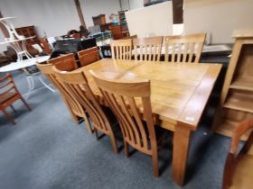 An oak extending dining table with 6 chairs.