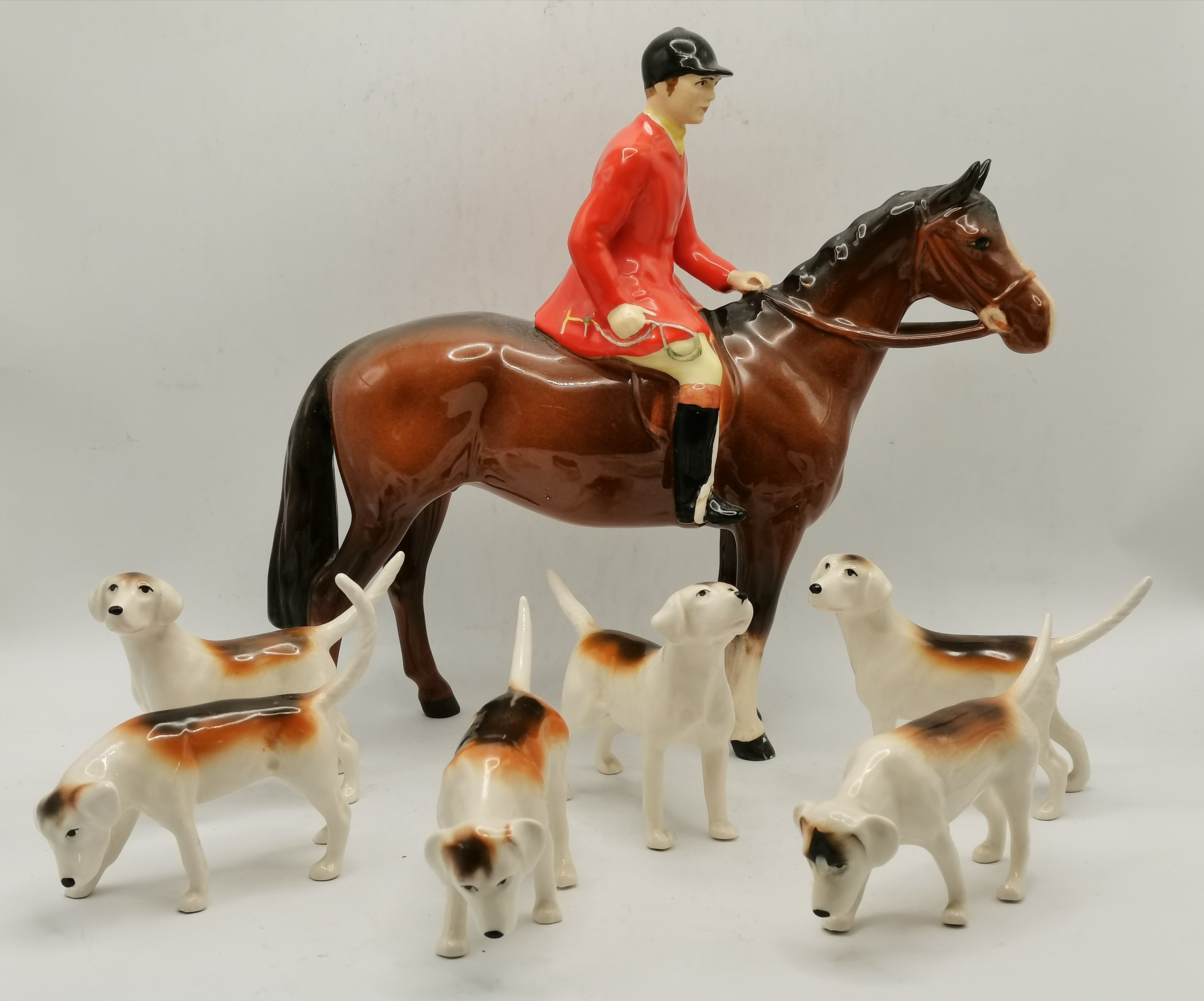 A Beswick huntsman and six foxhounds