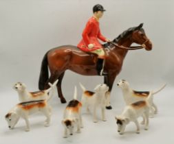 A Beswick huntsman and six foxhounds