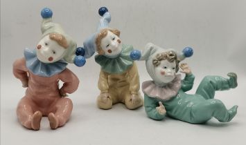 A group of three Nao porcelain child figures