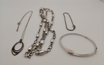 A group of silver necklaces and bracelets