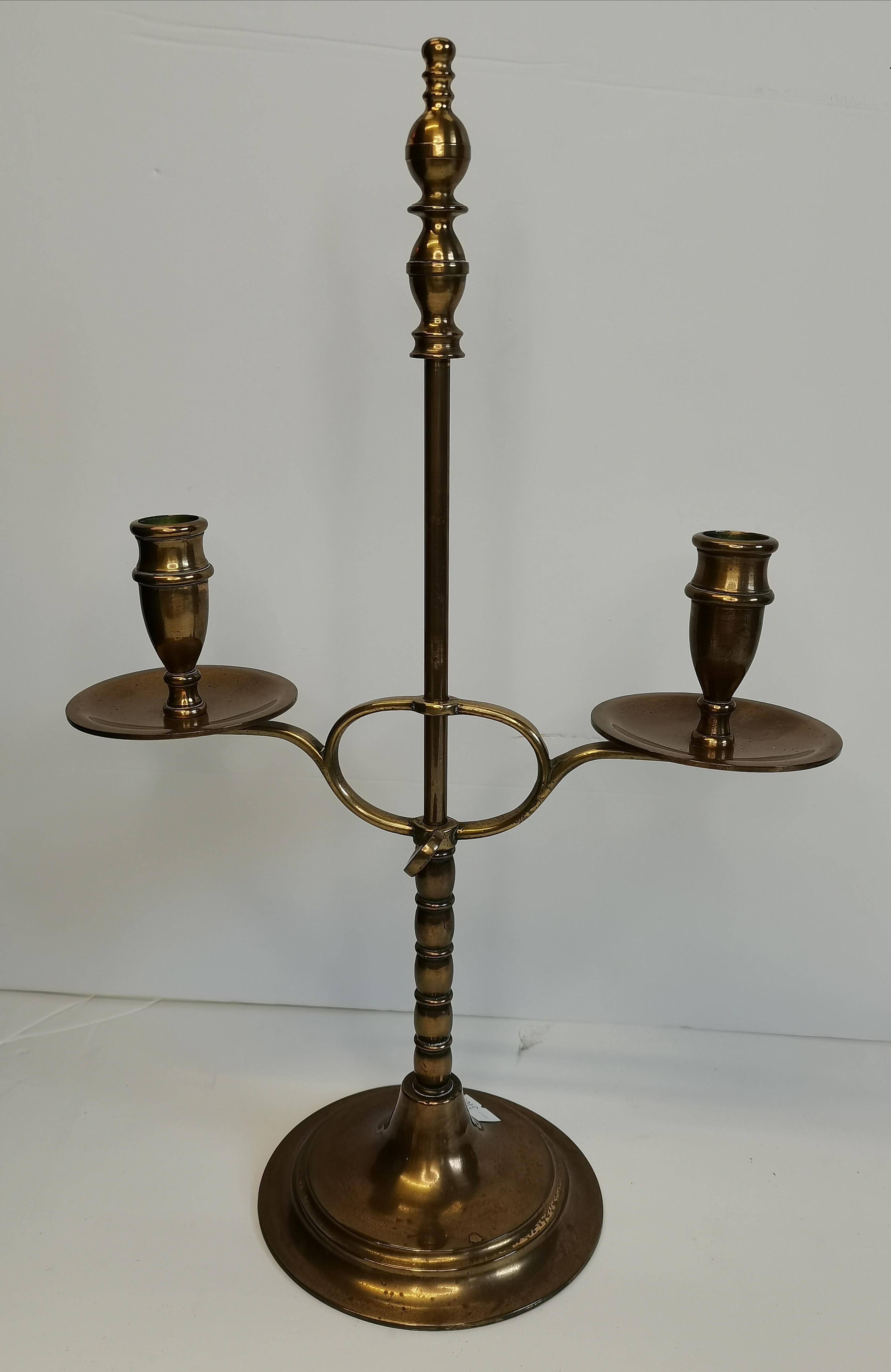 A vintage brass extending desk lamp with green shade