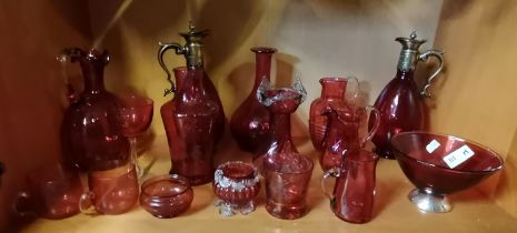 A good collection of ruby / cranberry glass claret jugs, vases etc
