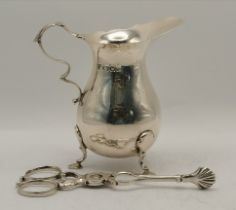 A pair of 18th Century silver scissor sugar tongs, and a 20th Century silver cream jug