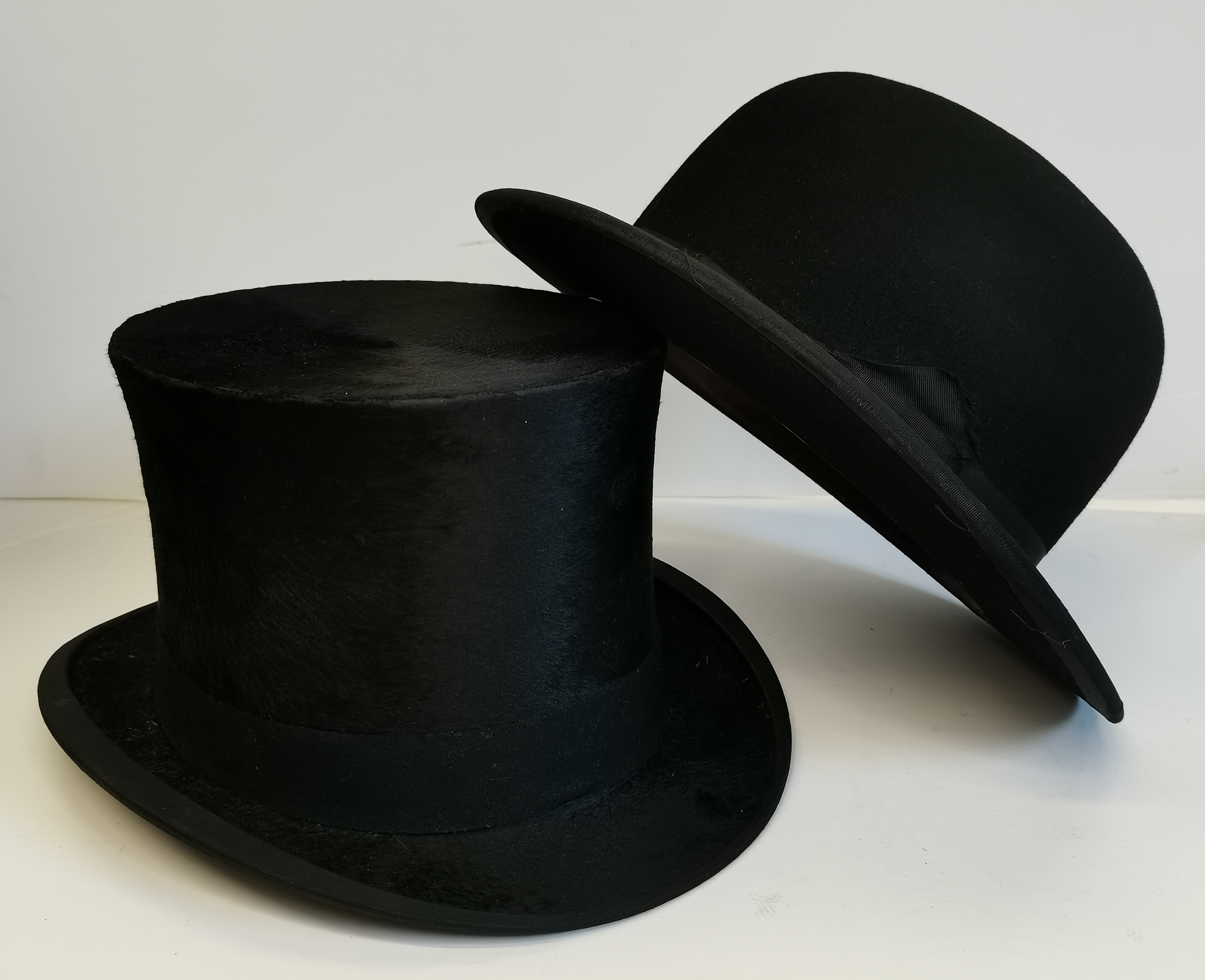 A top hat by WOODROW PICCADILLY LONDON 55.5CM DIAMETER, plus a bowler hat, silver topped ebony walki