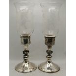 A pair of Elizabeth II silver hurricane lamp candlesticks