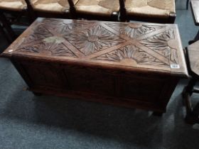 A 20th century decoratively carved blanket box