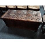 A 20th century decoratively carved blanket box