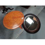 An African style travelling side table plus an Arts and crafts style oval wall mirror