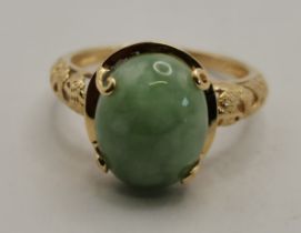 A 14 carat gold jade ring