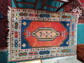 Wool rug in blue, red, pink and green