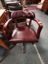 An oxblood leather swivel captain's chair