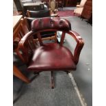 An oxblood leather swivel captain's chair