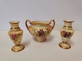 A Royal Worcester blush ivory twin-handled pedestal bowl and small pair of baluster vases
